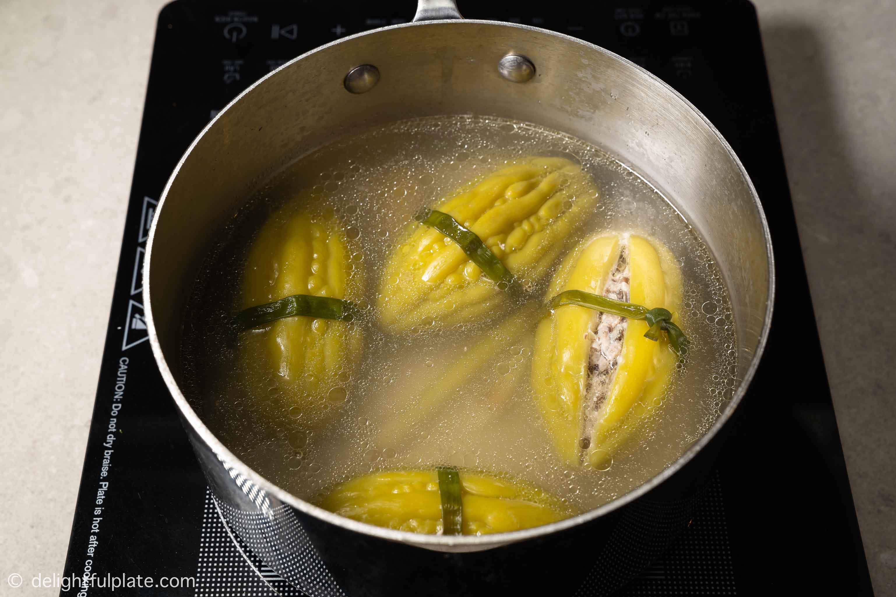 cooking stuffed bitter melon on the stove