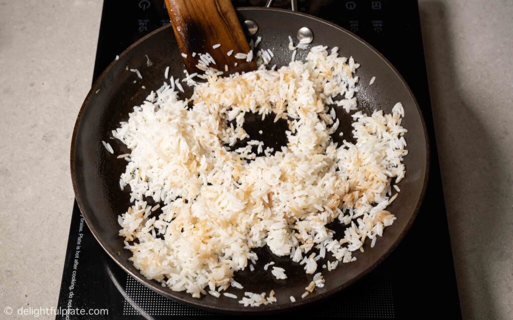 frying the rice in a pan