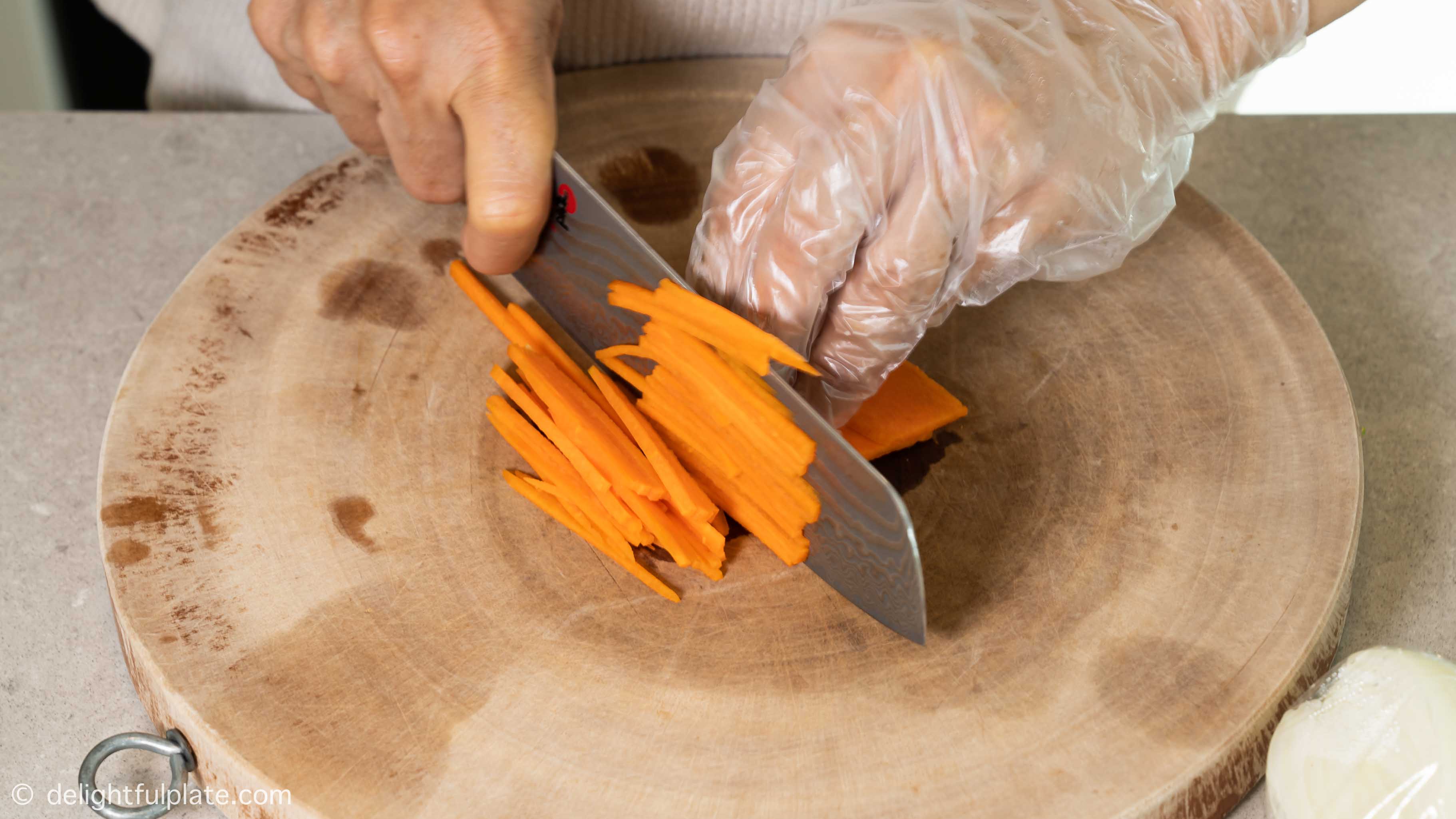Julienne carrot on a cutting board.