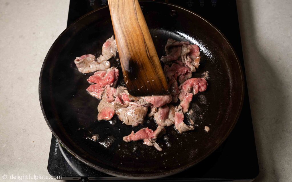 sautéing beef in a pan