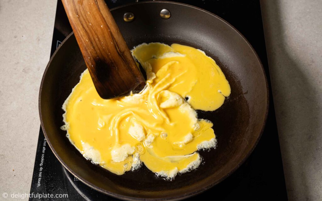 scrambling eggs in a pan