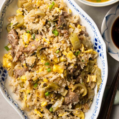 a plate of Vietnamese beef fried rice with pickled mustard greens (com rang dua bo)
