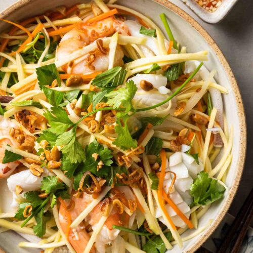 a plate of Vietnamese green mango salad with seafood.