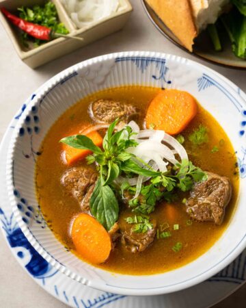 a bowl of bo kho (Vietnamese beef stew) served with banh mi