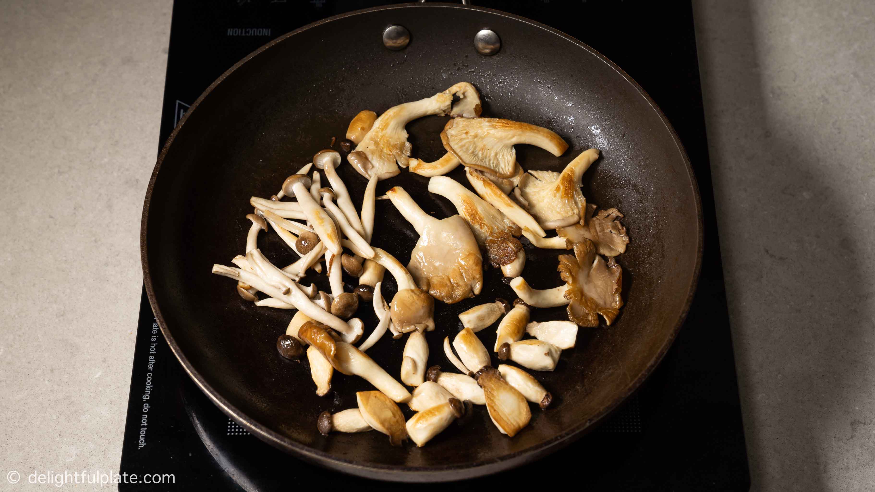 browning mushrooms in a hot pan