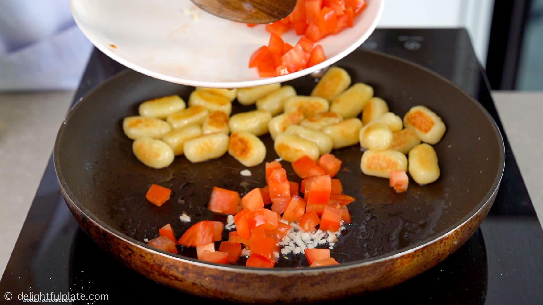 add diced tomatoes to the pan