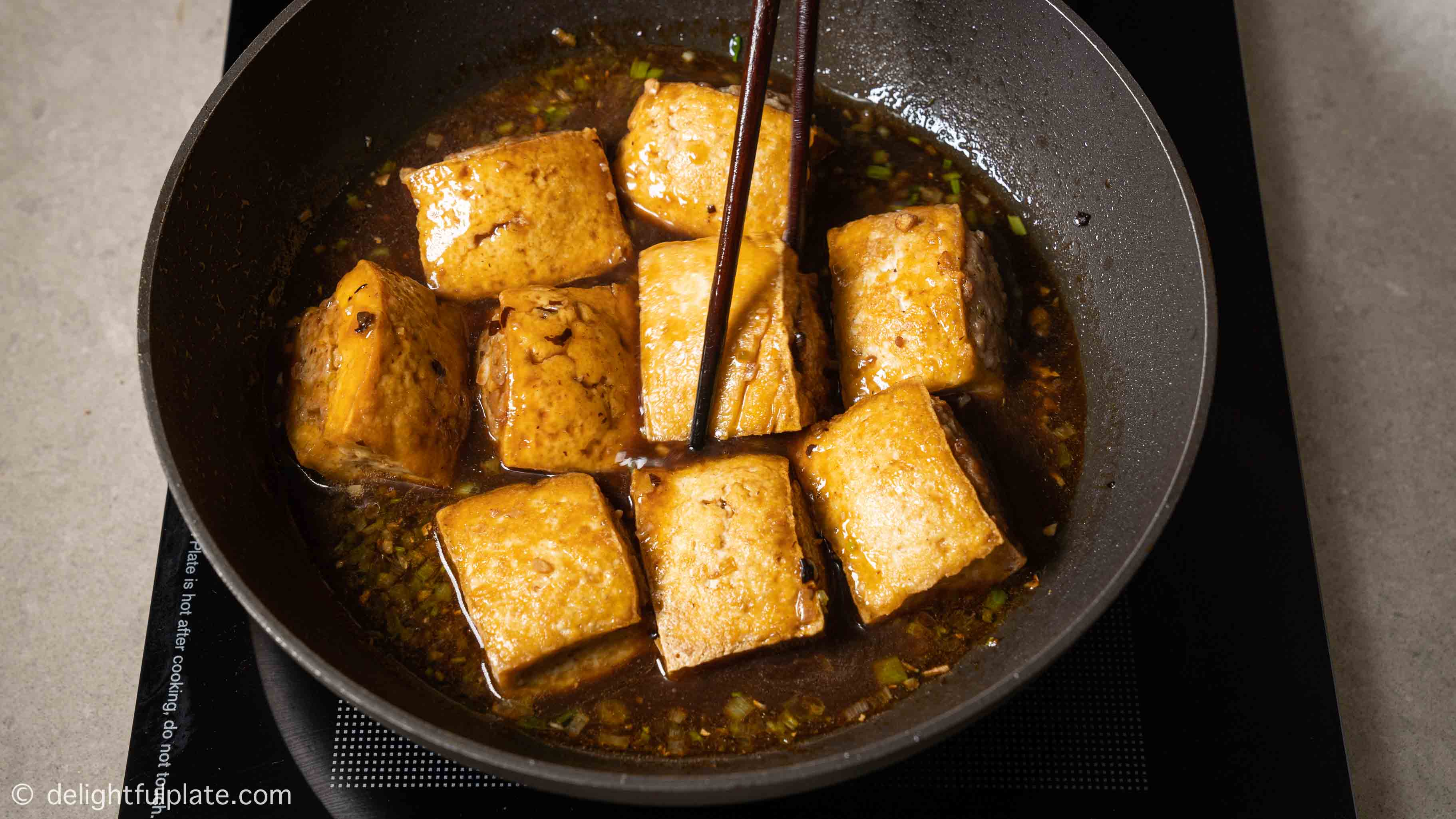 simmering tofu in black bean sauce