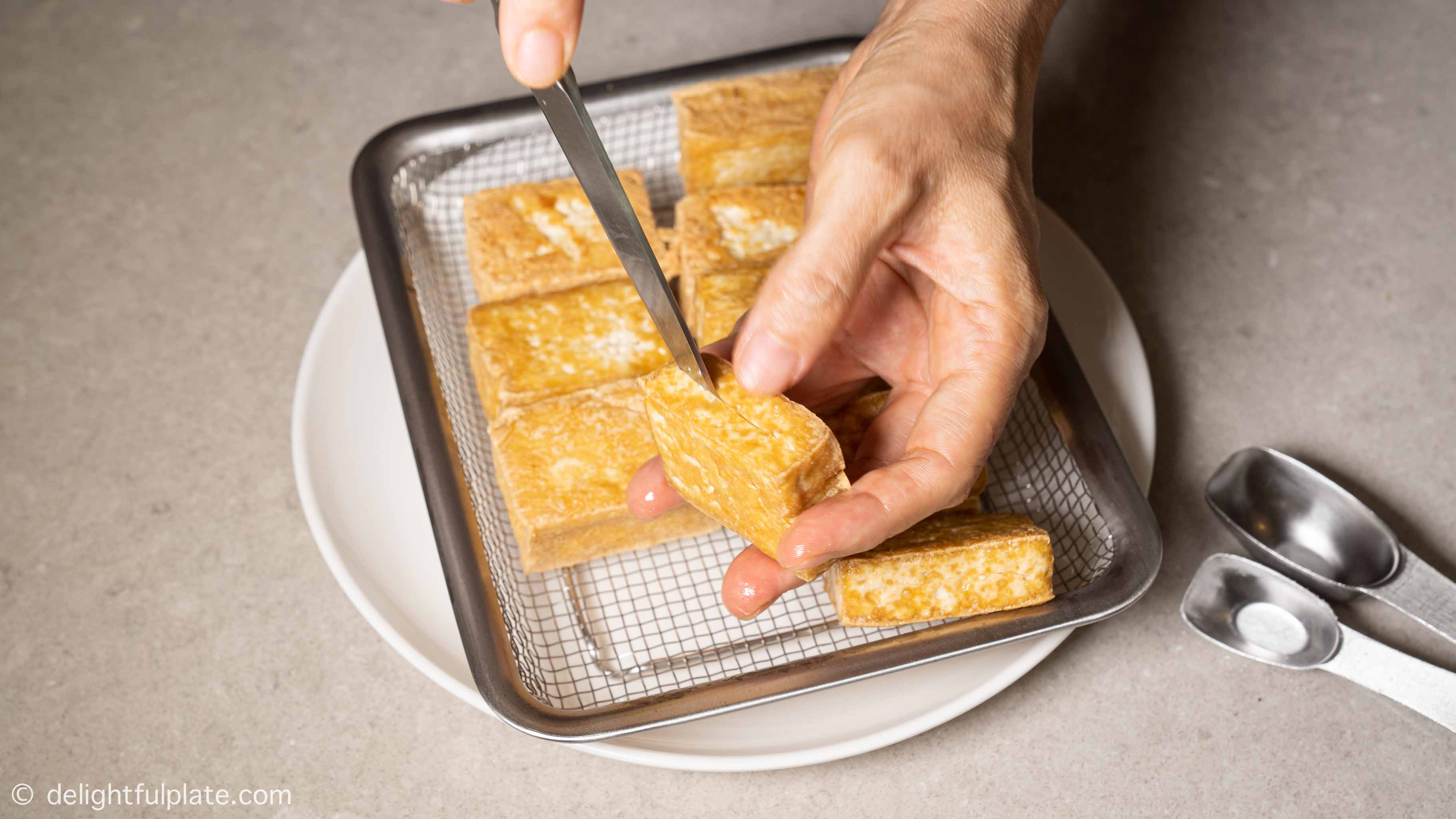 slicing the tofu to create a pocket