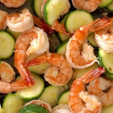 a pan of shrimp being sauteed with zucchini