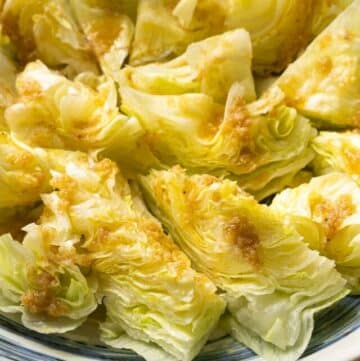 a plate of lettuce with ginger dressing