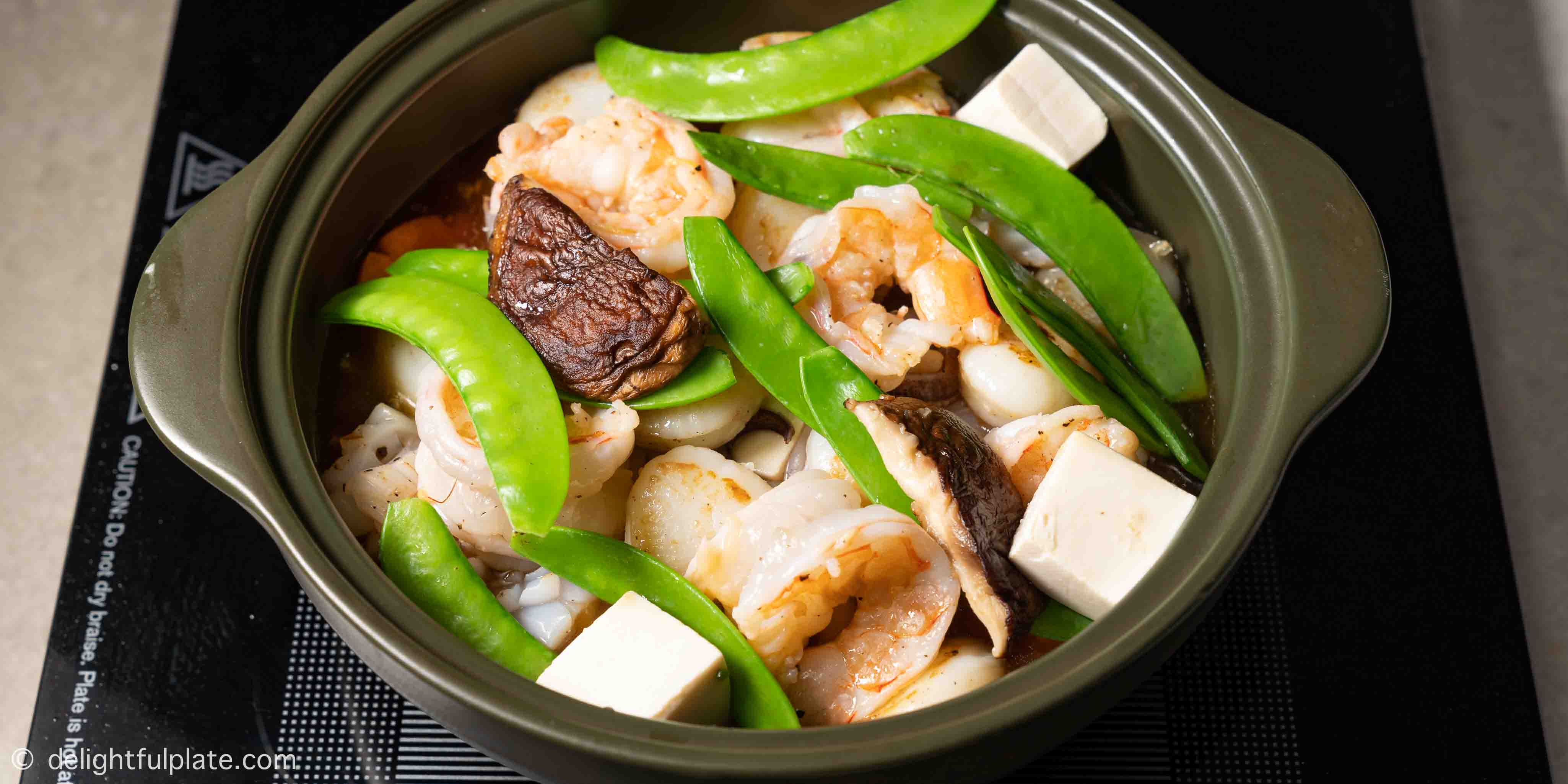 adding seafood and snow peas to the pot