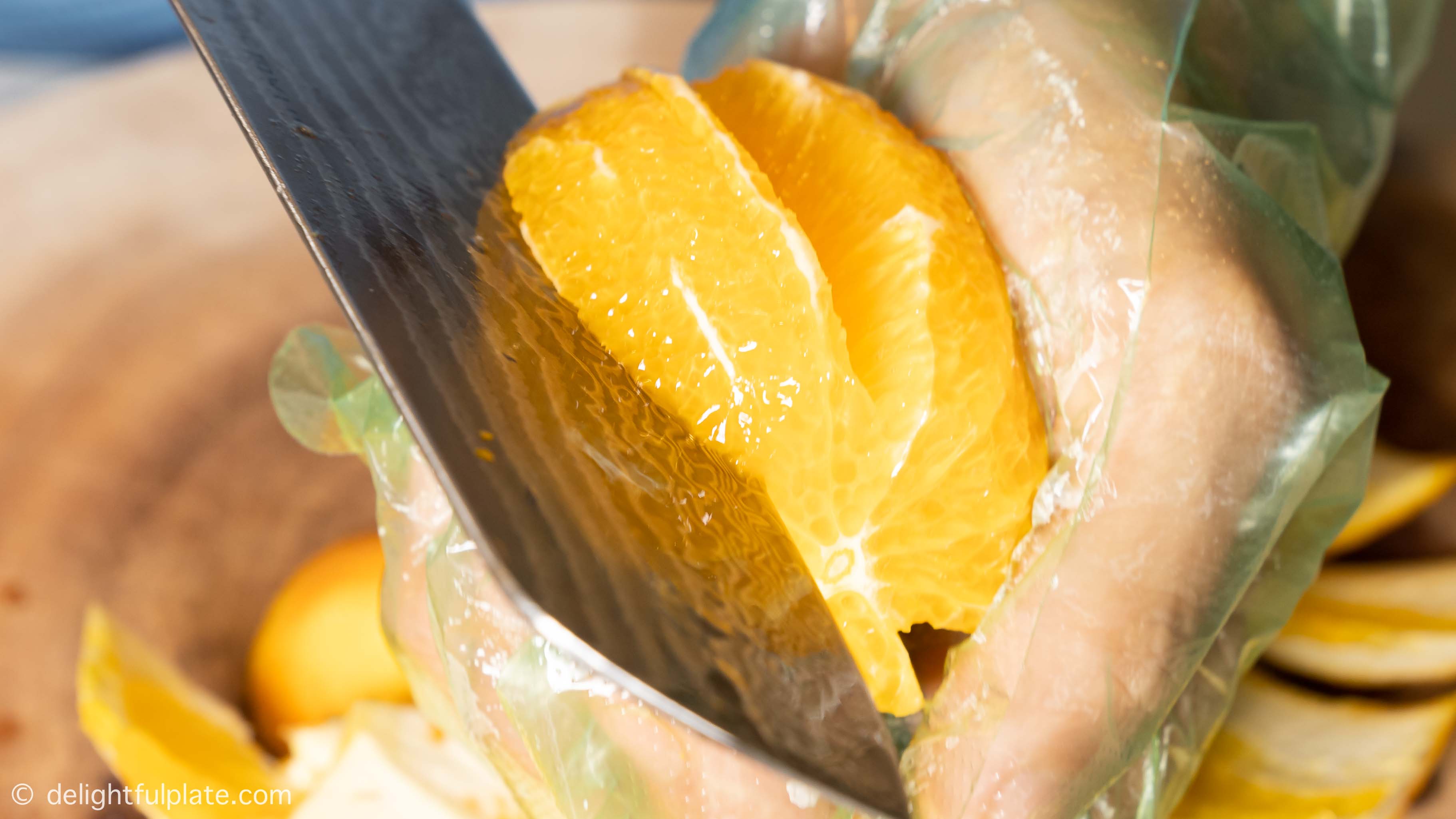 slicing oranges into segments with a knife