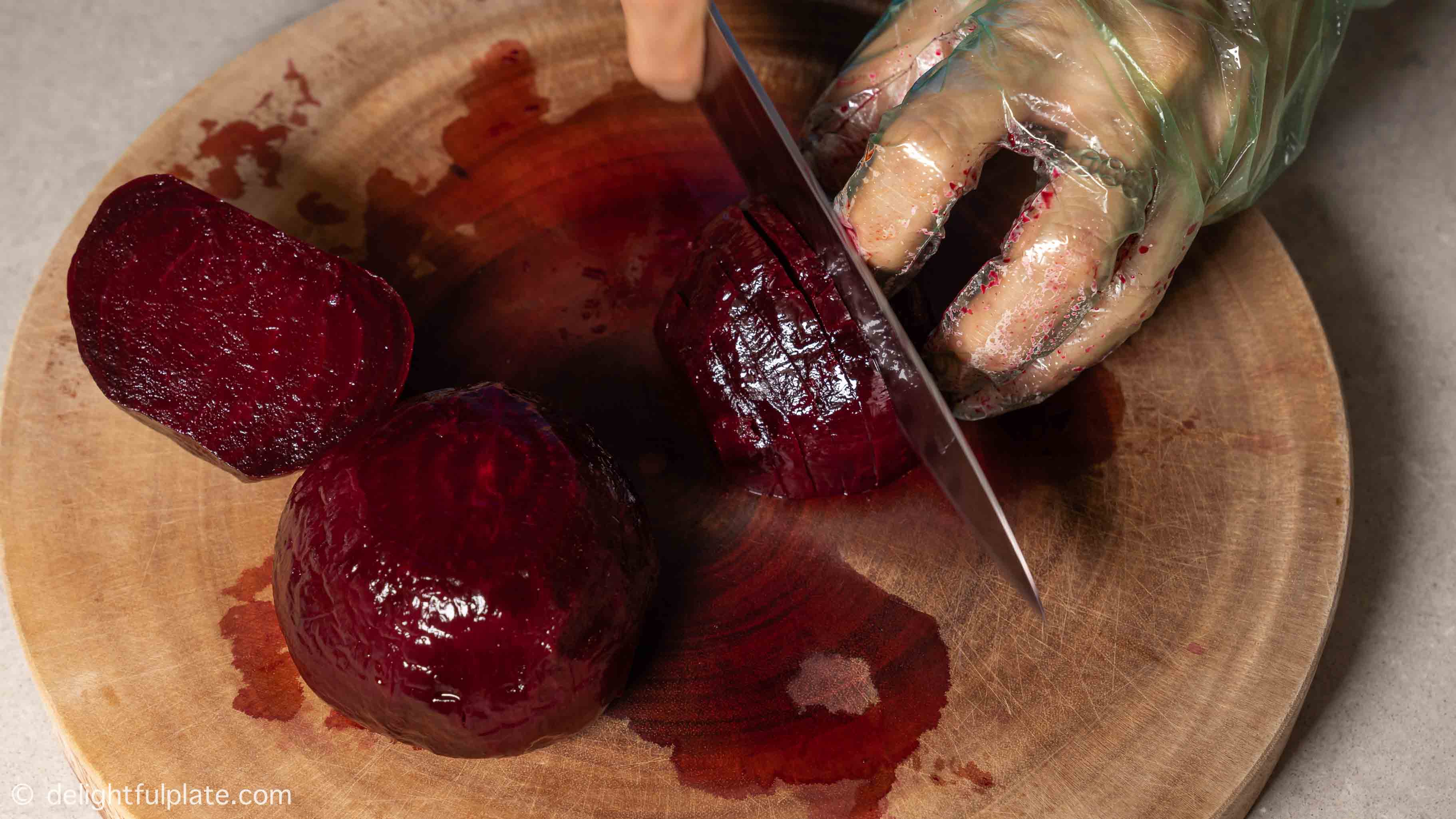 slicing roasted beetroot on a cutting board