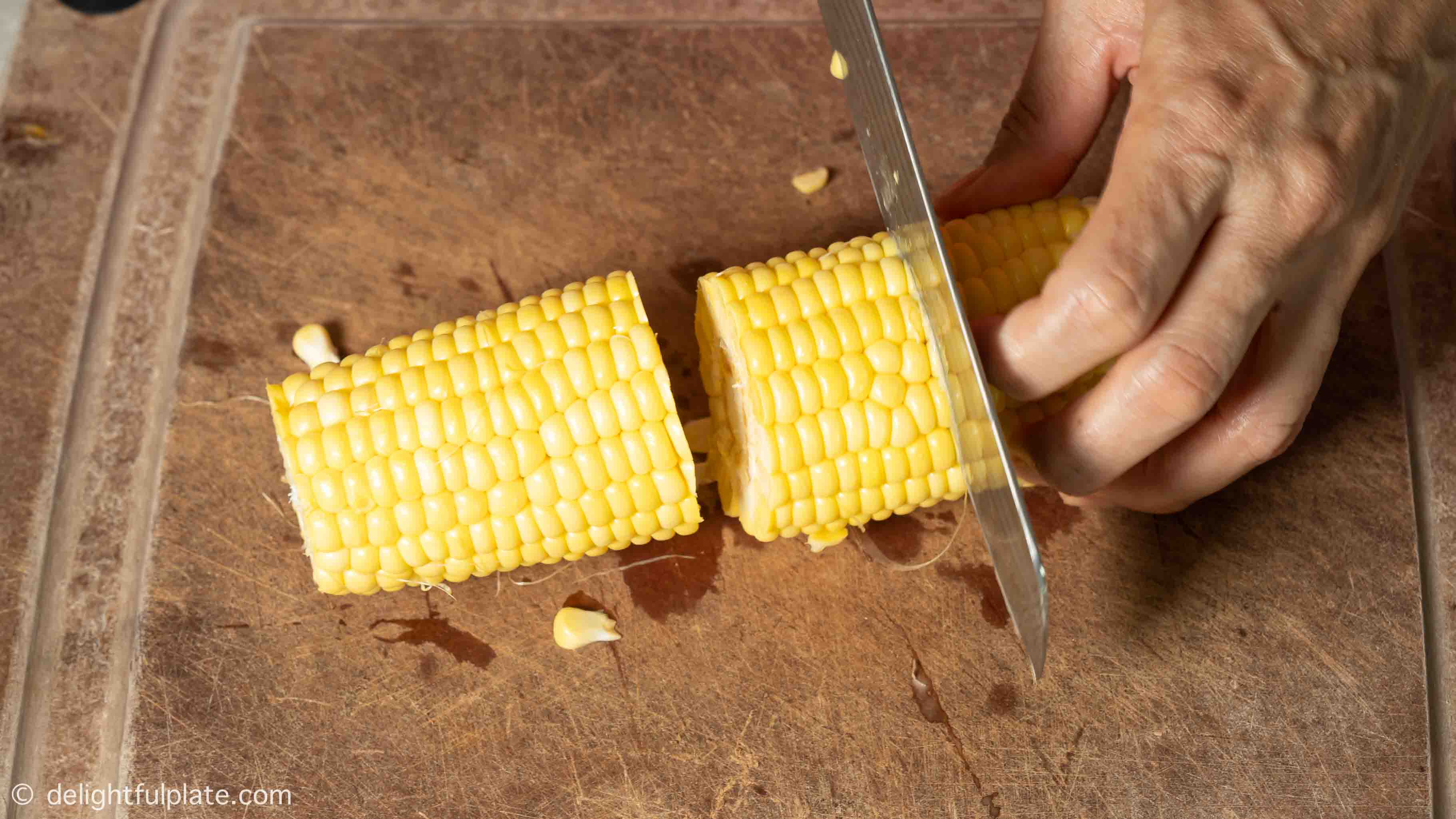 chopping corn on a cutting board