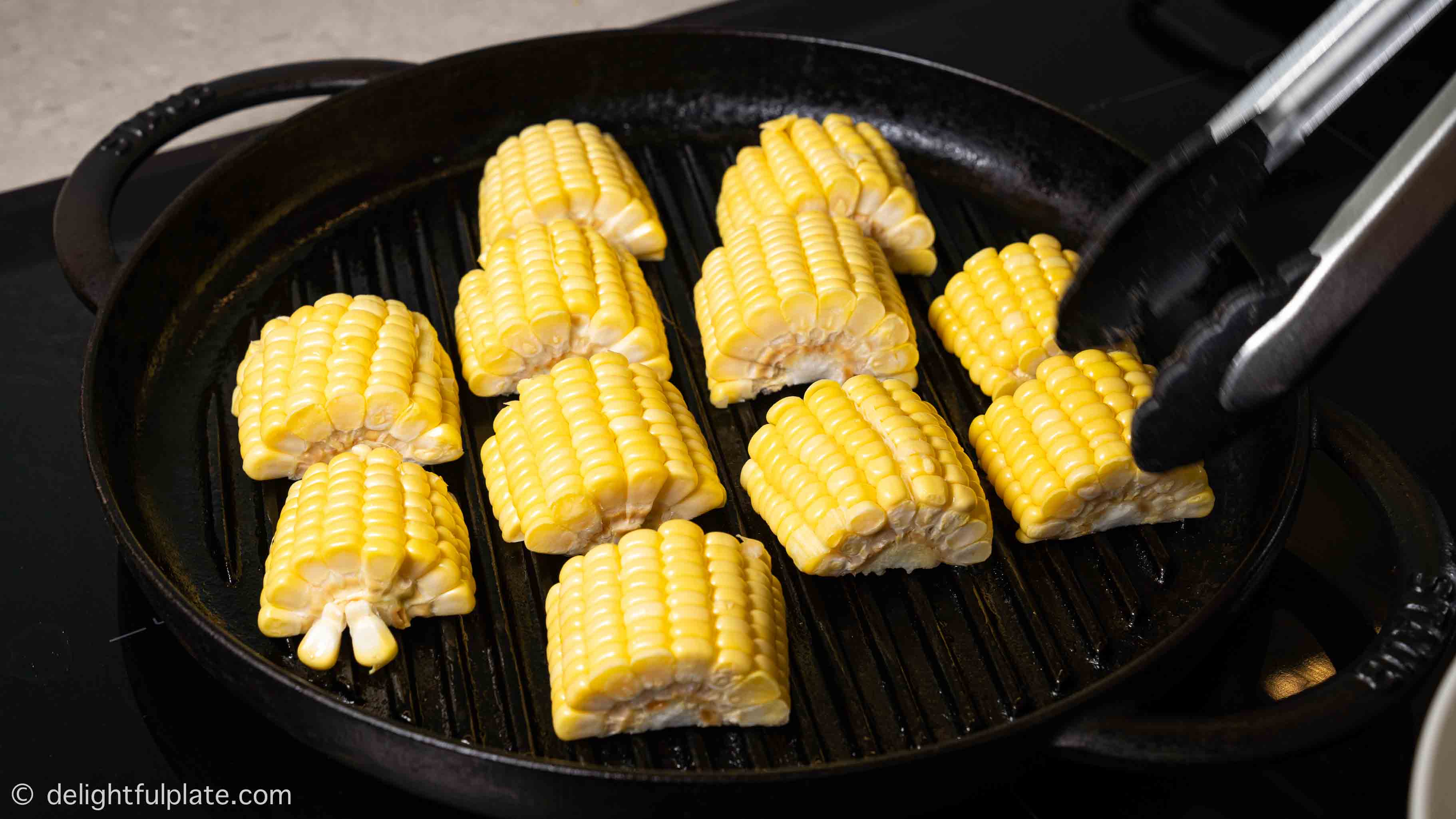 placing corn on the grill