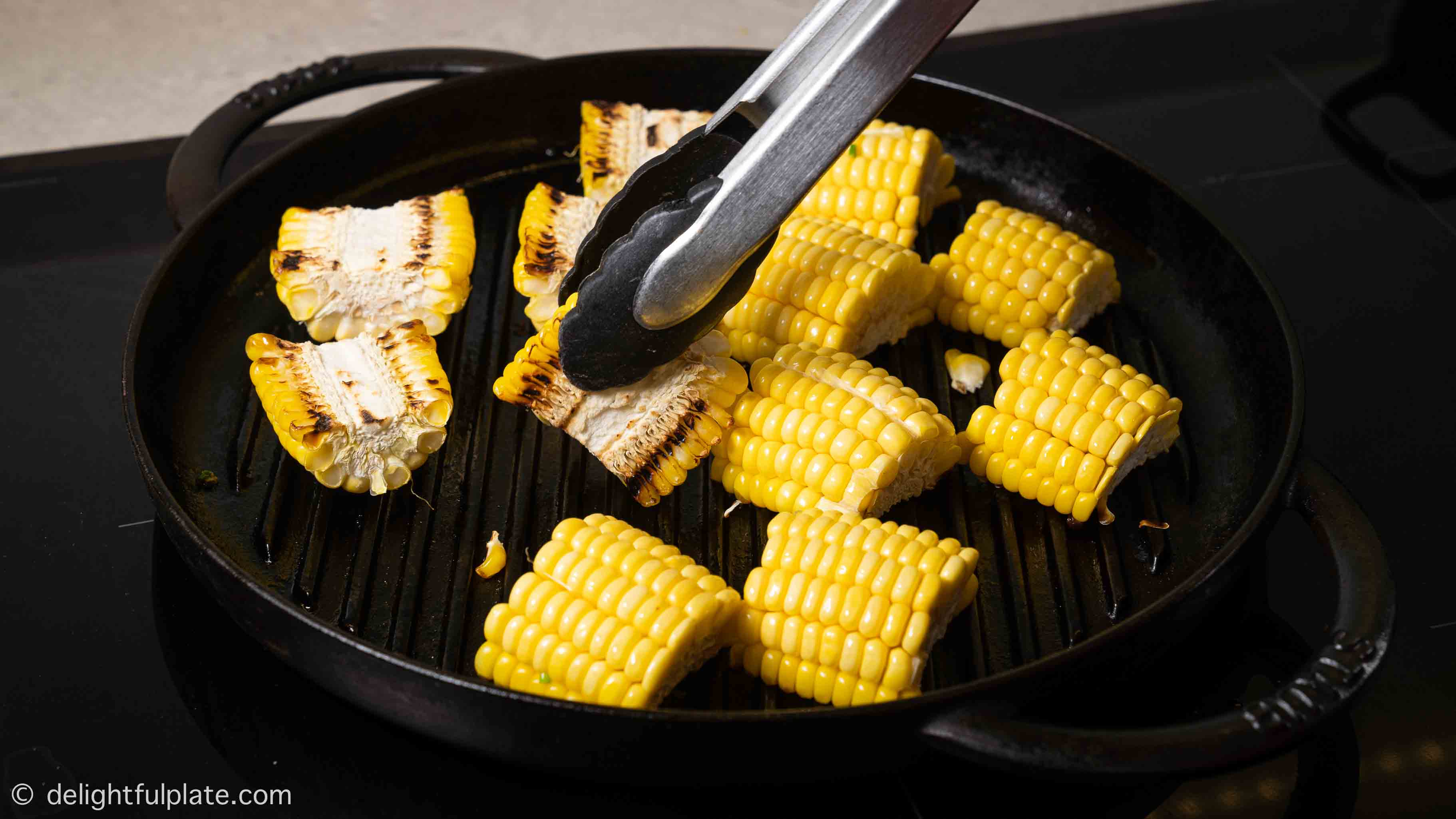 turning grilled corn