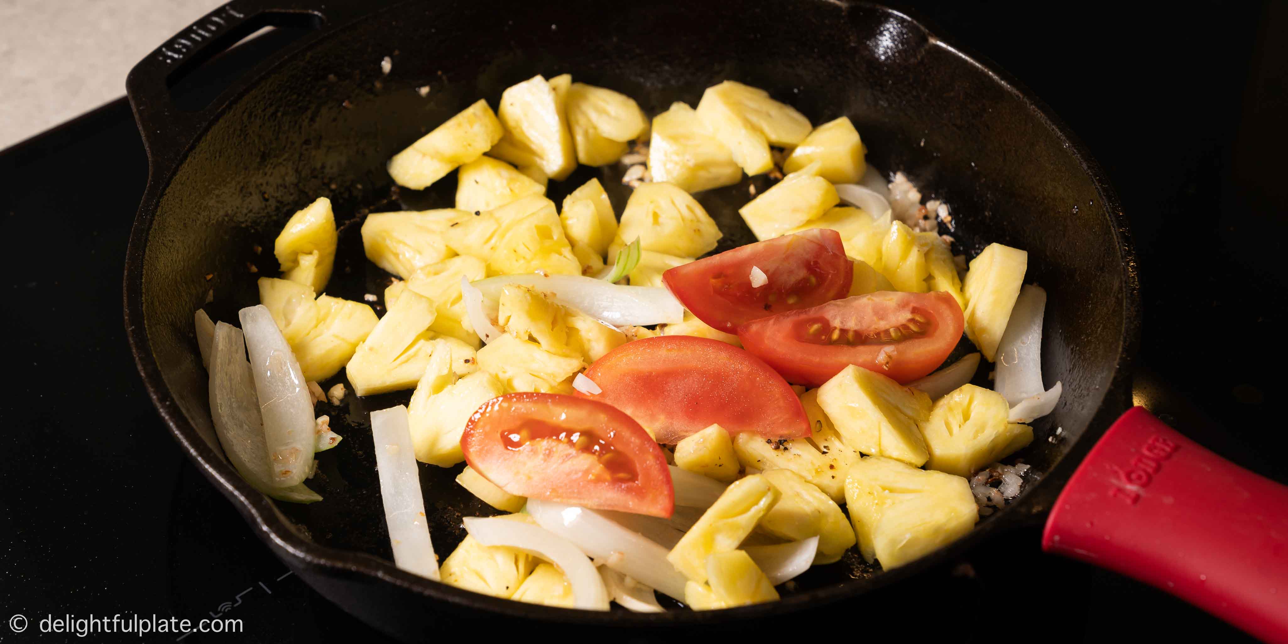 stir frying aromatics and pineapple