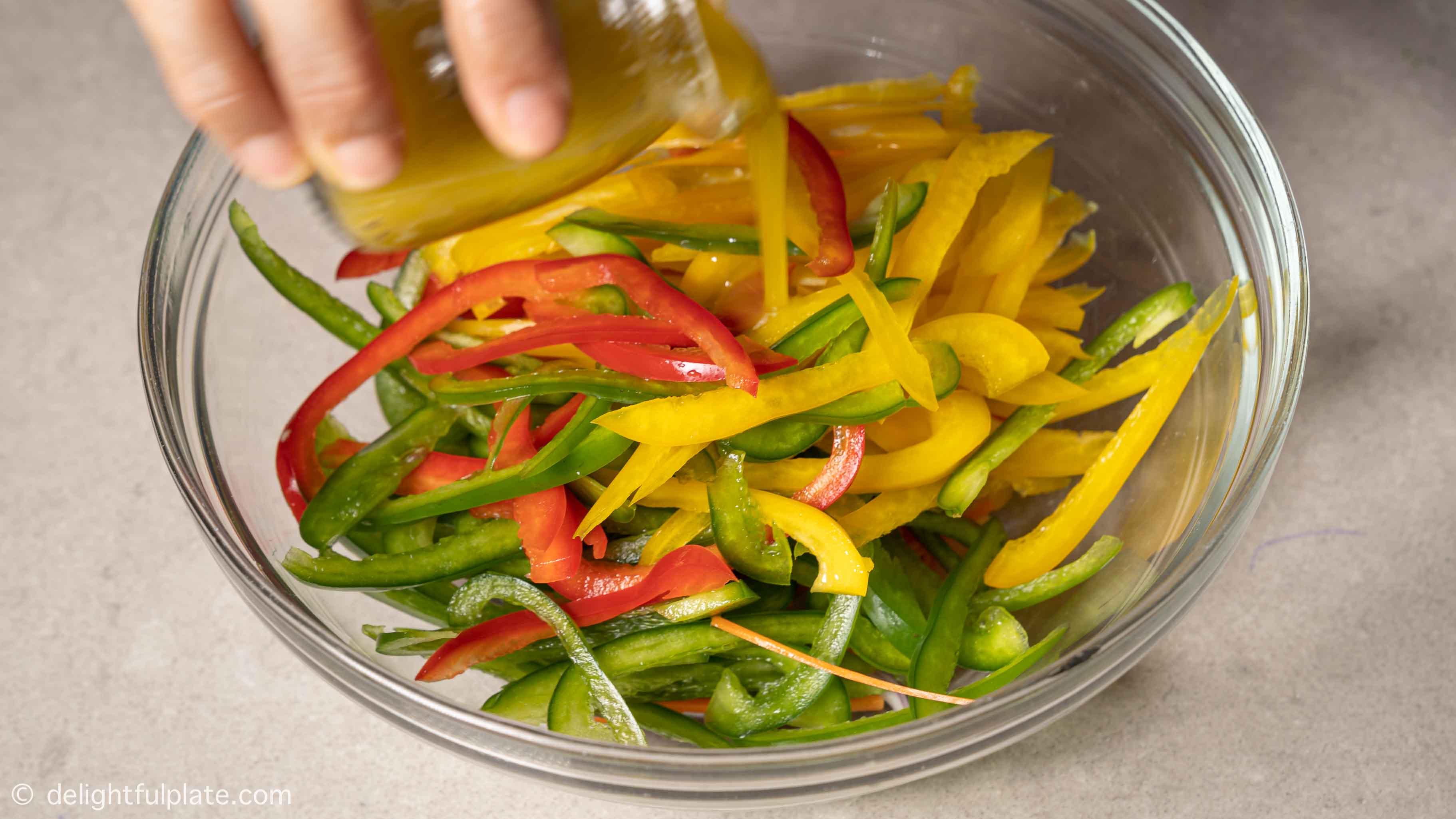 pouring dressing over bell peppers