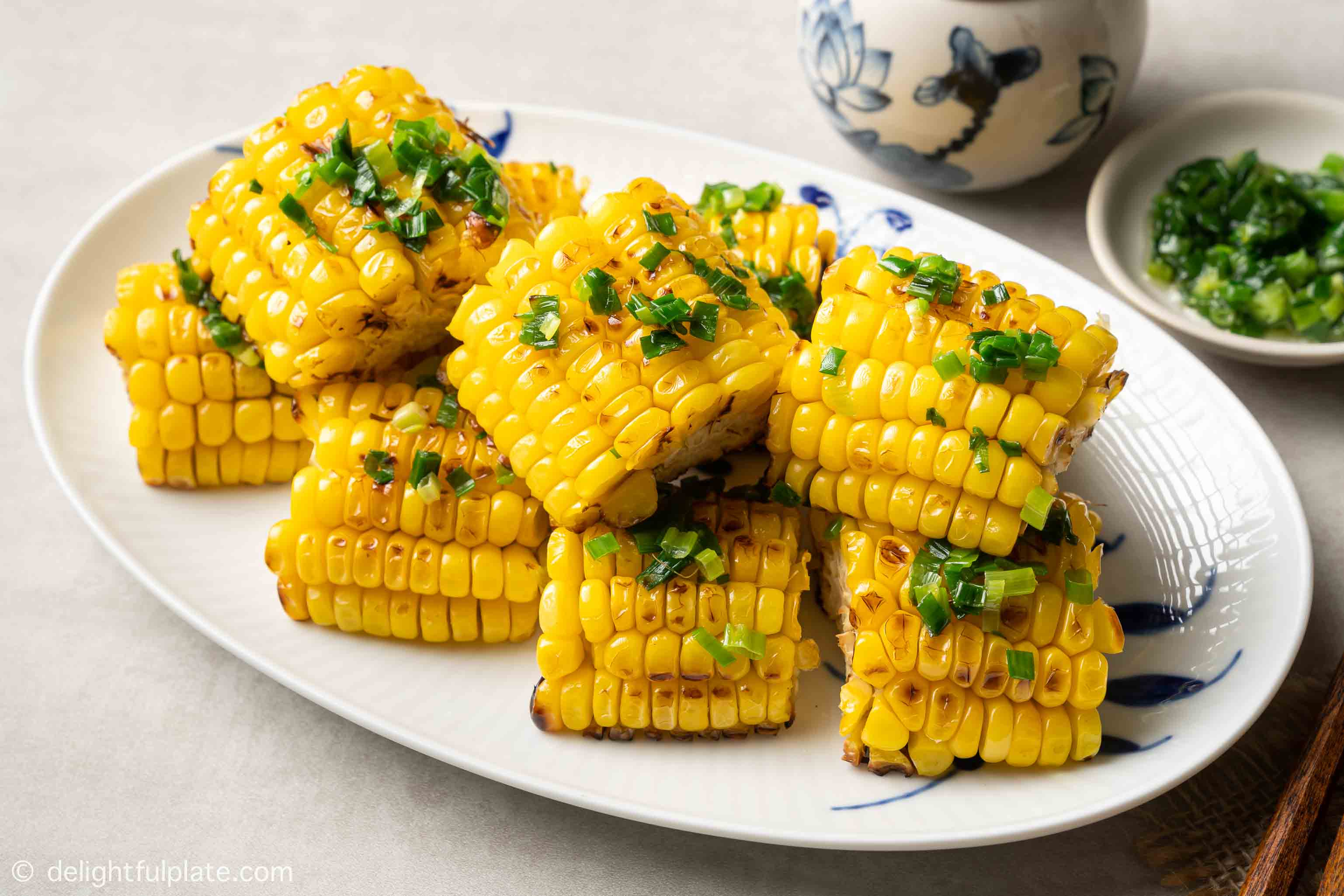 a plate of Vietnamese grilled corn with scallion oil