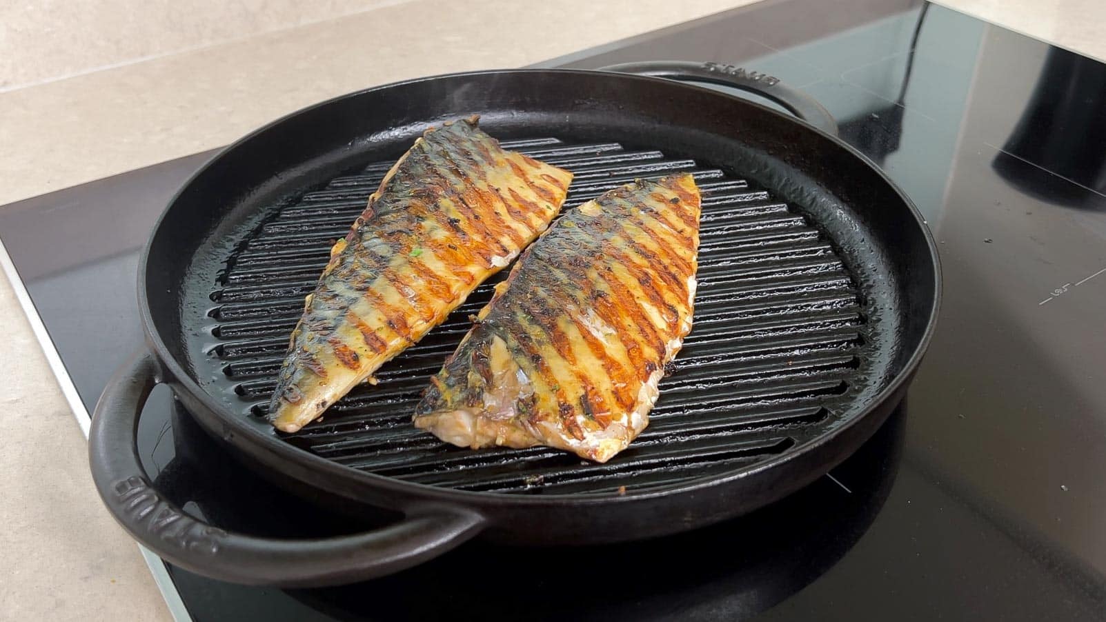 cooking the mackerel fillets on a grill pan