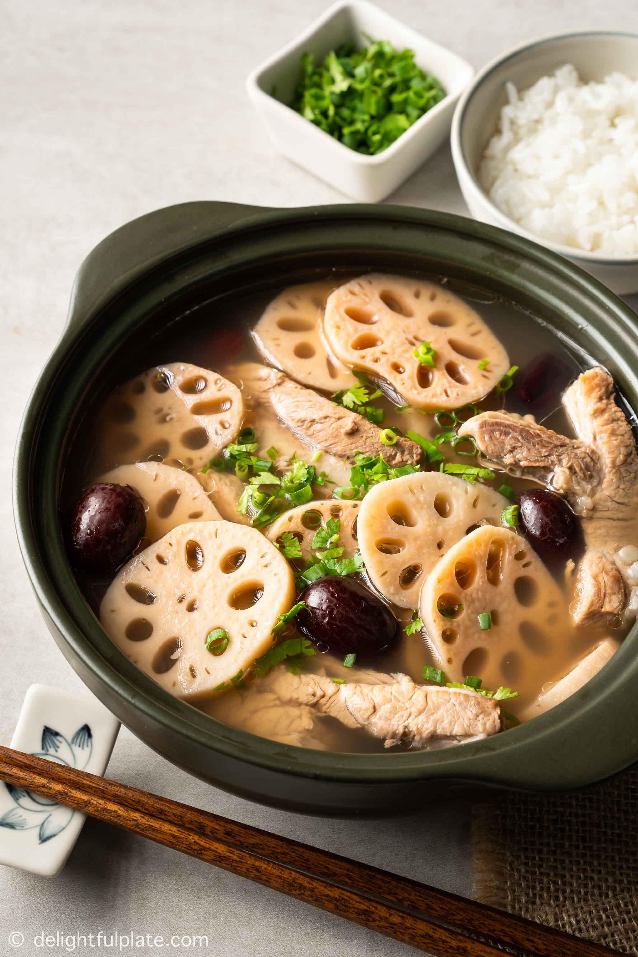 a bowl of lotus root soup with pork rib, with rice on the side