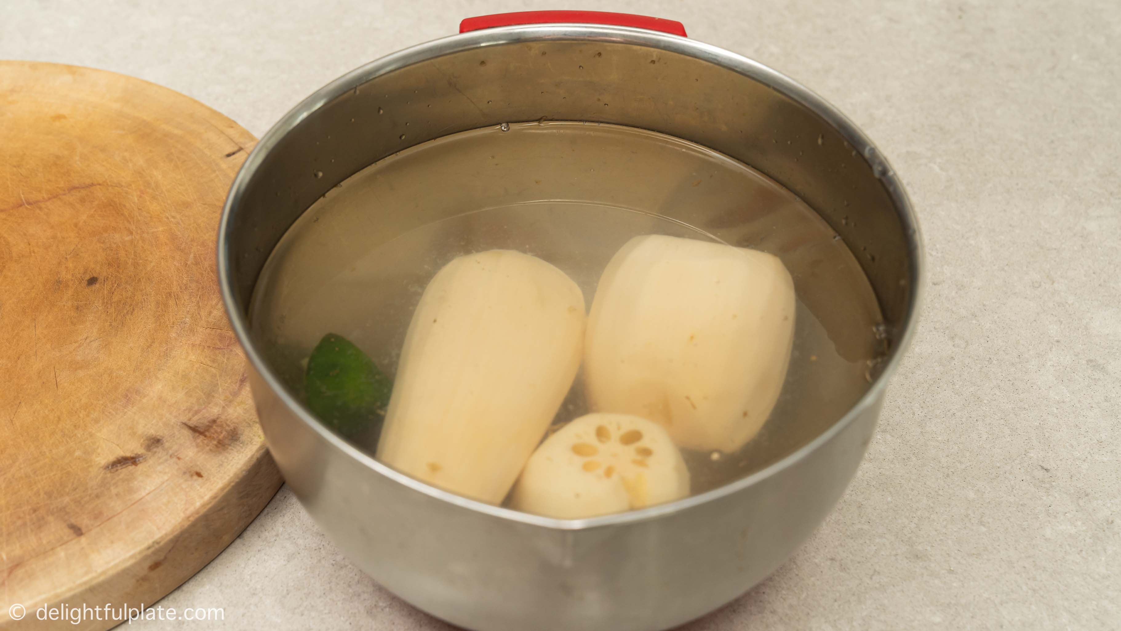 soaking lotus root in water with some lime juice
