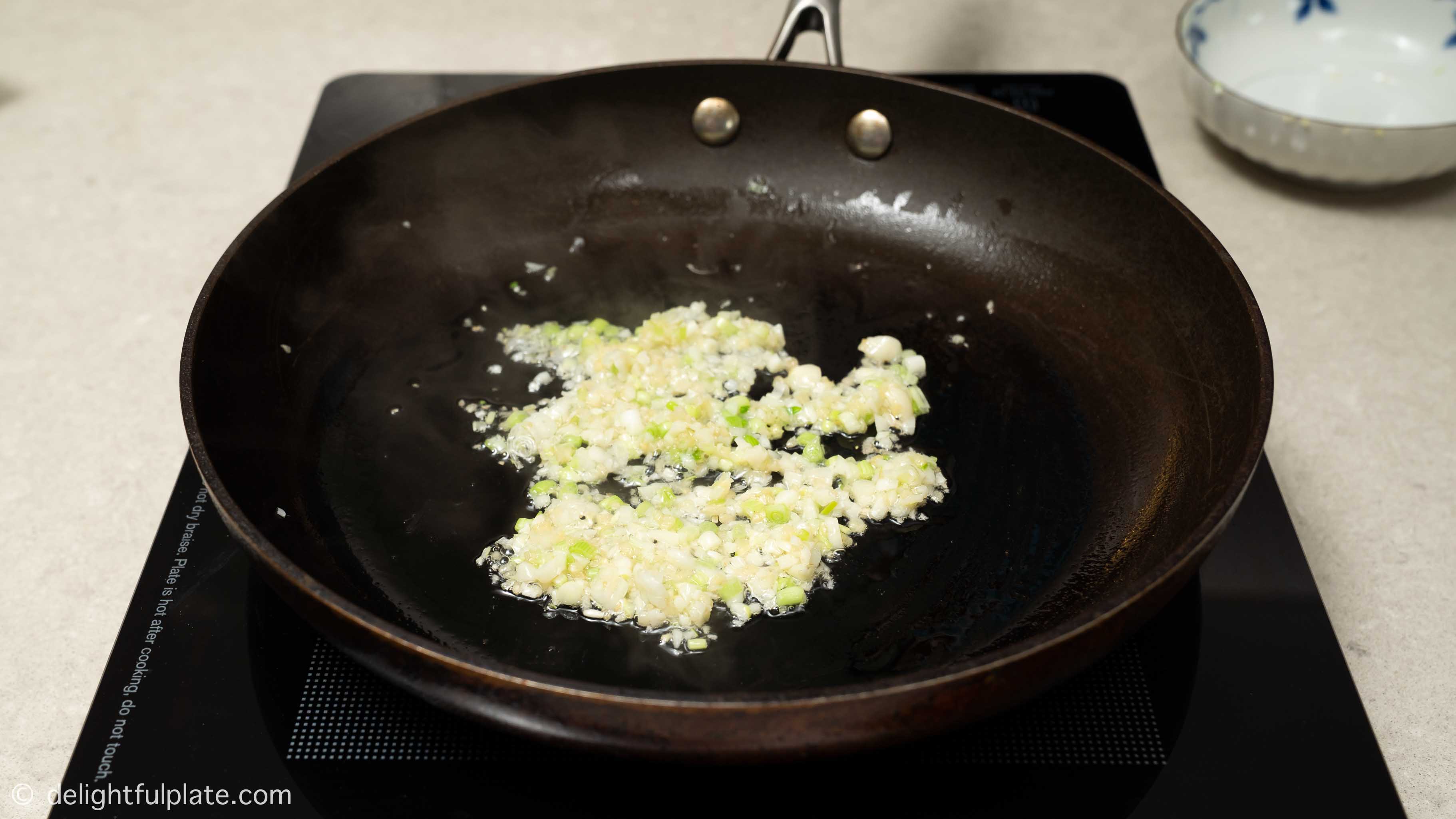 Sautéing aromatics in a pan
