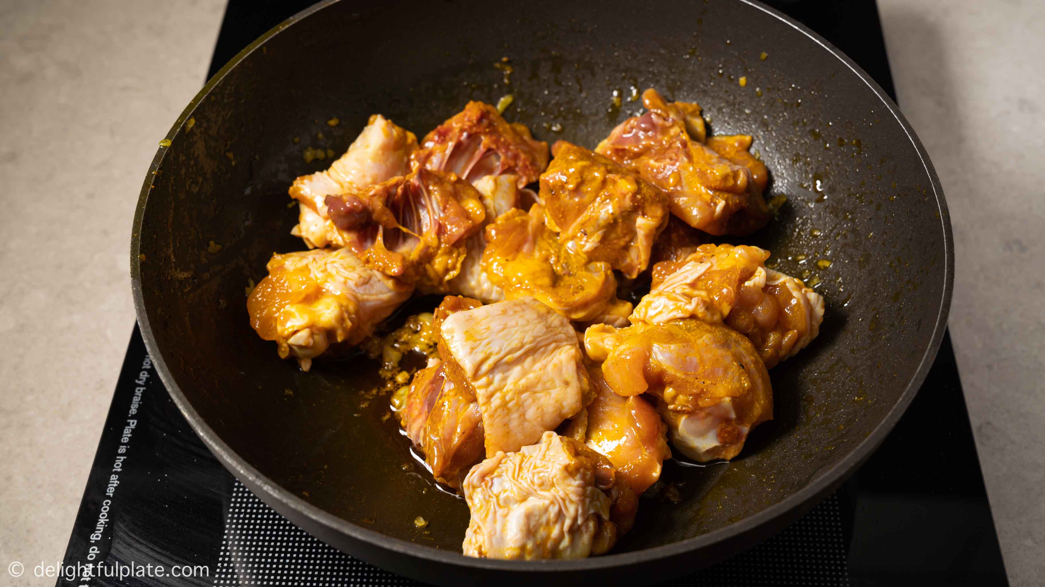 Saute chicken thighs and drumsticks in a skillet
