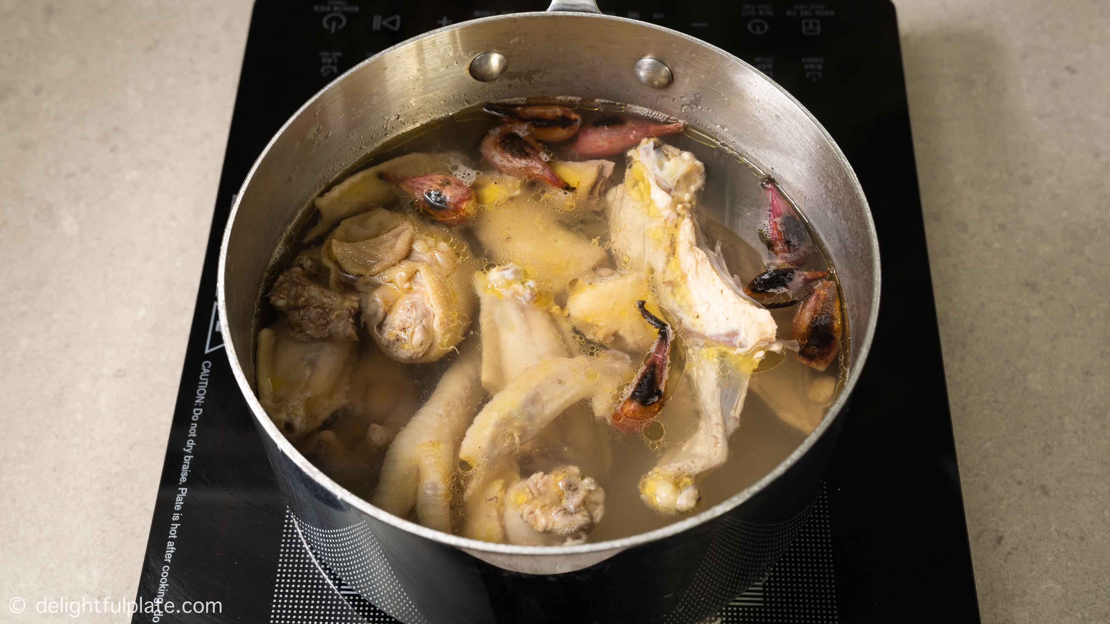 simmer chicken stock in a pot