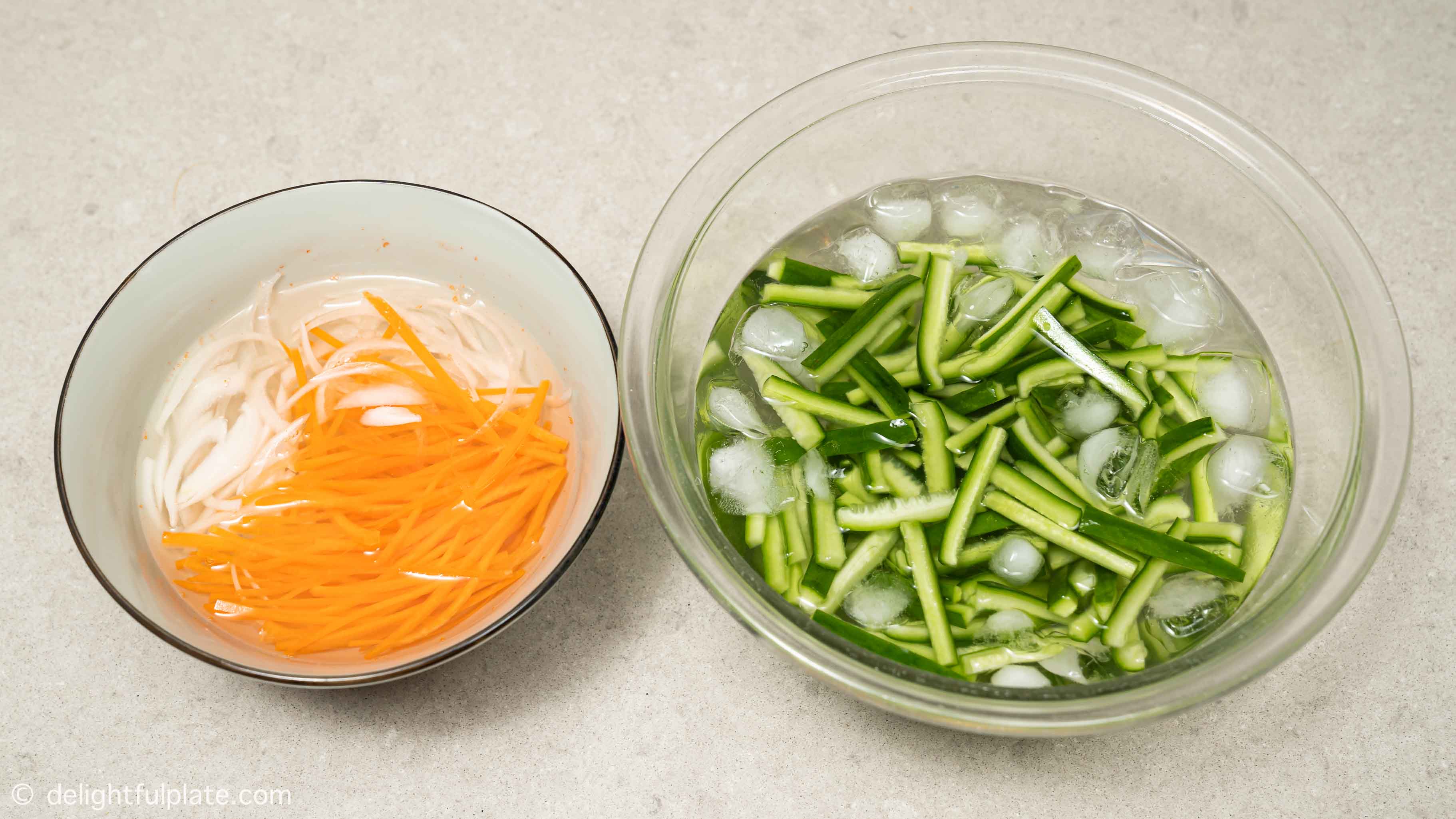 two bowls of water with soaked vegetables