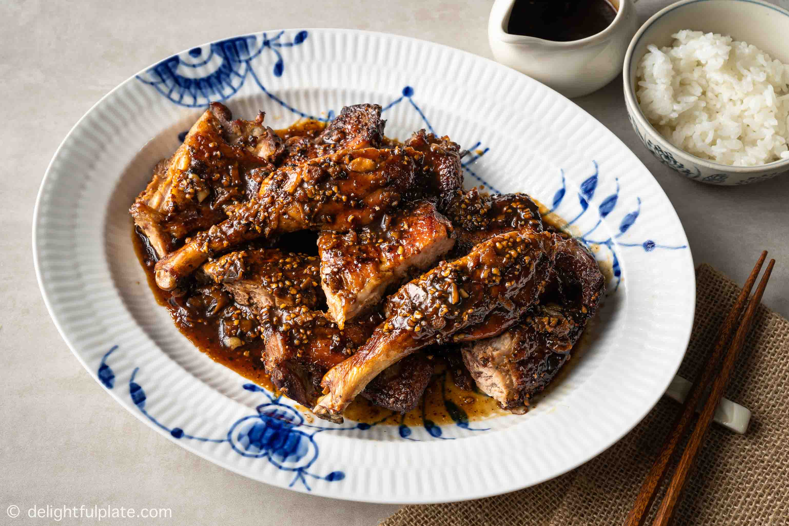 a plate of chopped roasted duck legs, served with black pepper sauce and rice