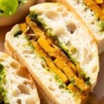 a slice of roasted butter squash sandwich with caramelized onions and pesto