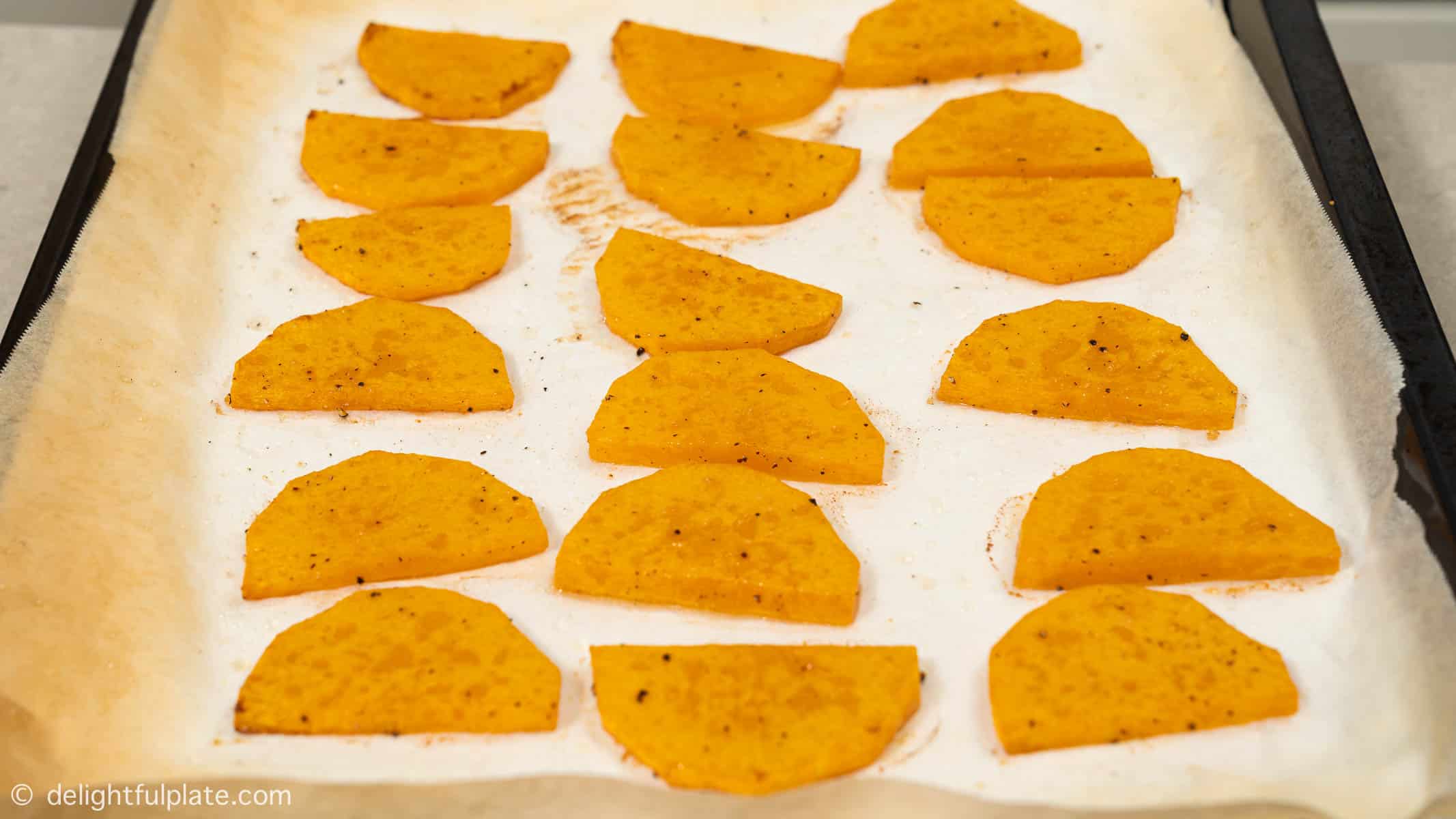 roasted butternut squash slices on a baking sheet