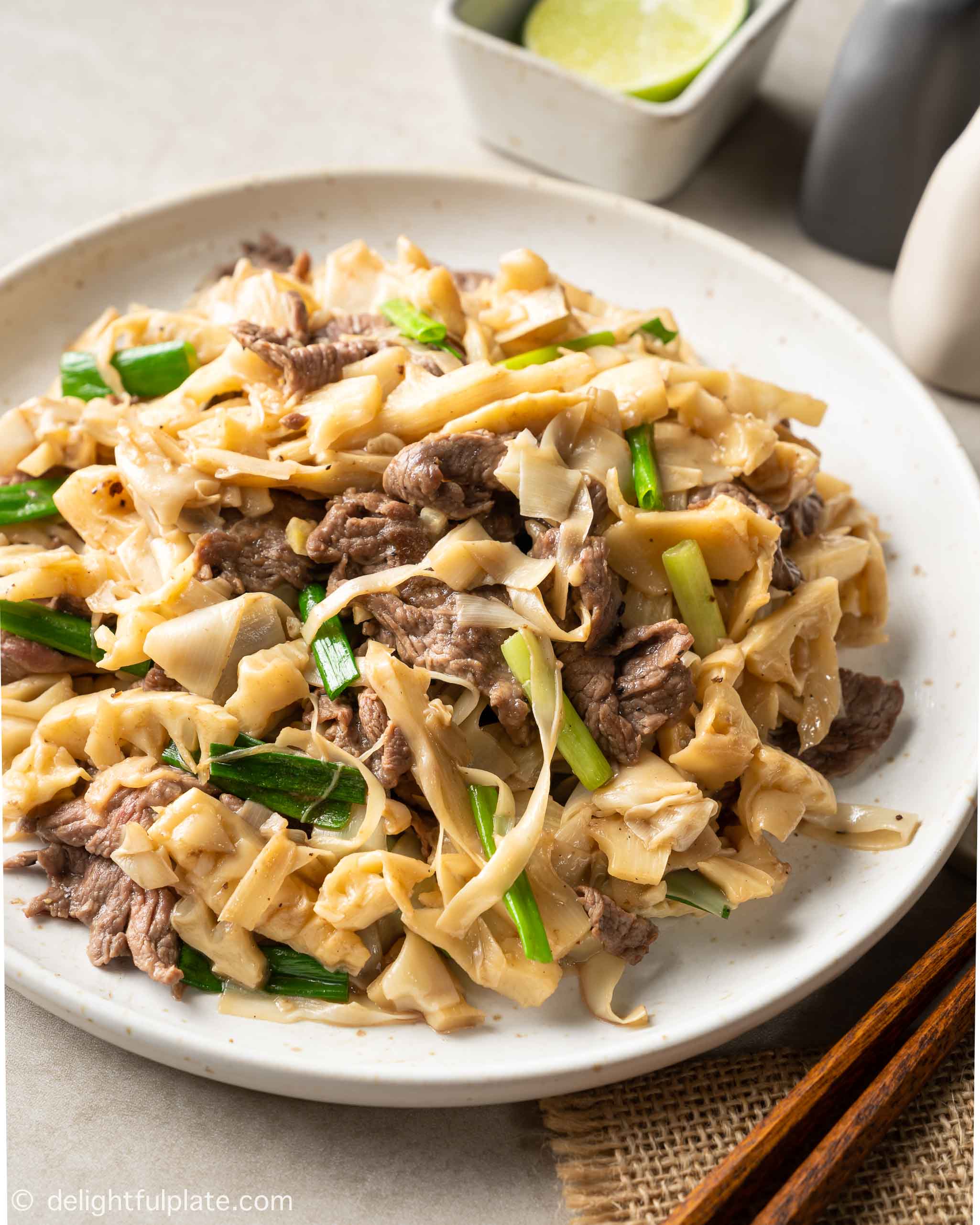 a plate of beef with bamboo shoots stir-fry