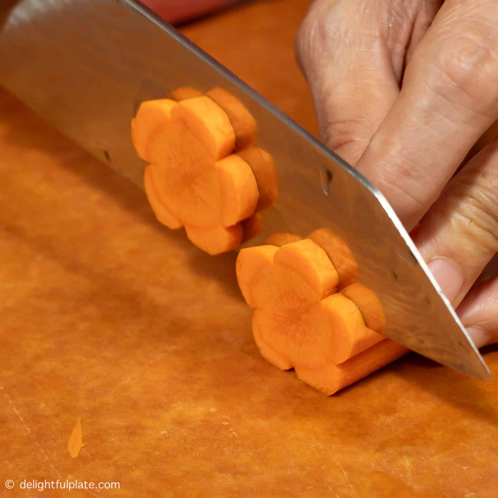 slicing carrot into flower shape.