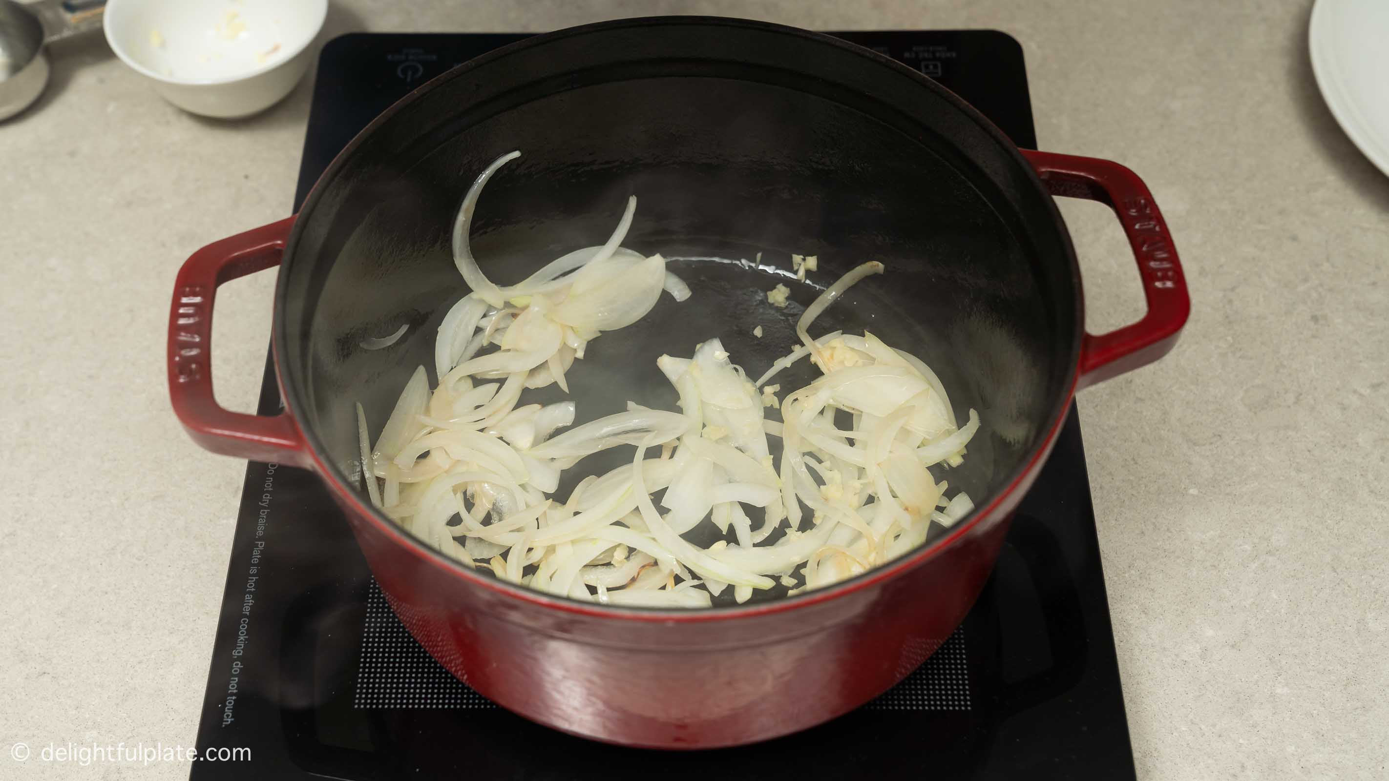 sautéing onion and garlic in a pot.