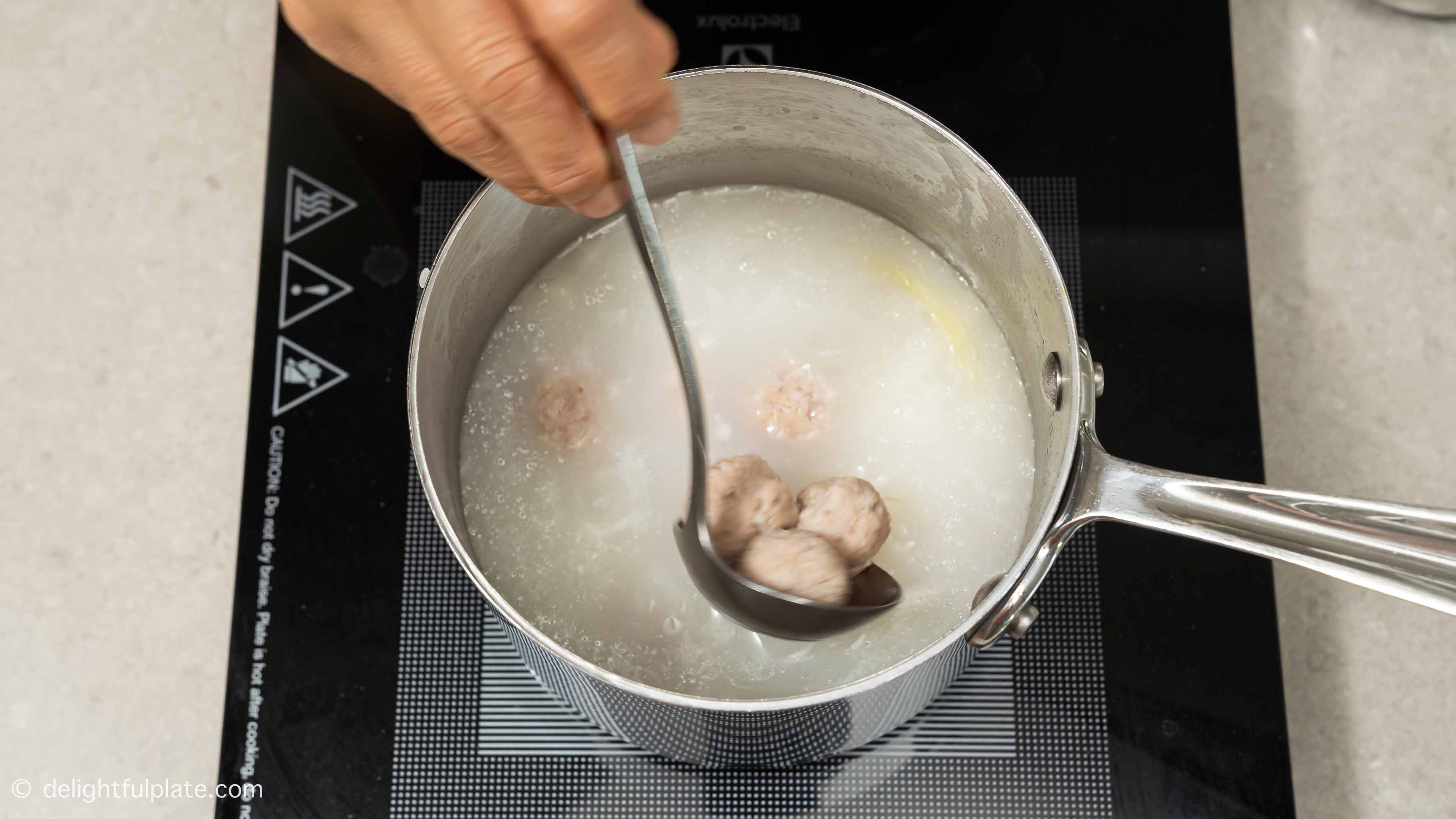 adding cooked meatballs back to the congee.