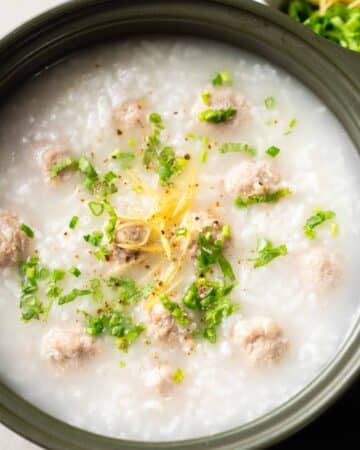 a small pot of congee with pork meatballs.