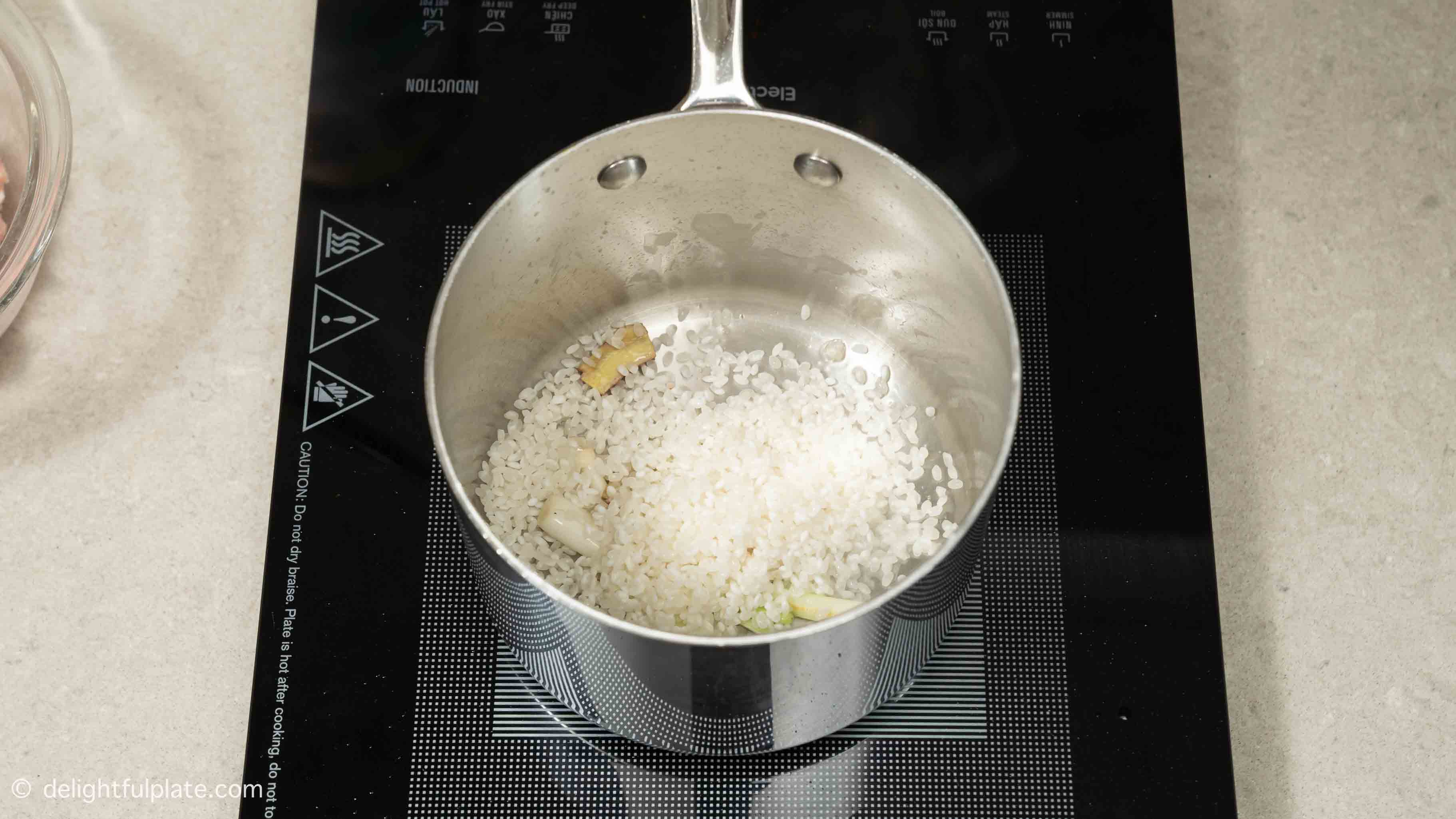 rice being sautéed in the pot.