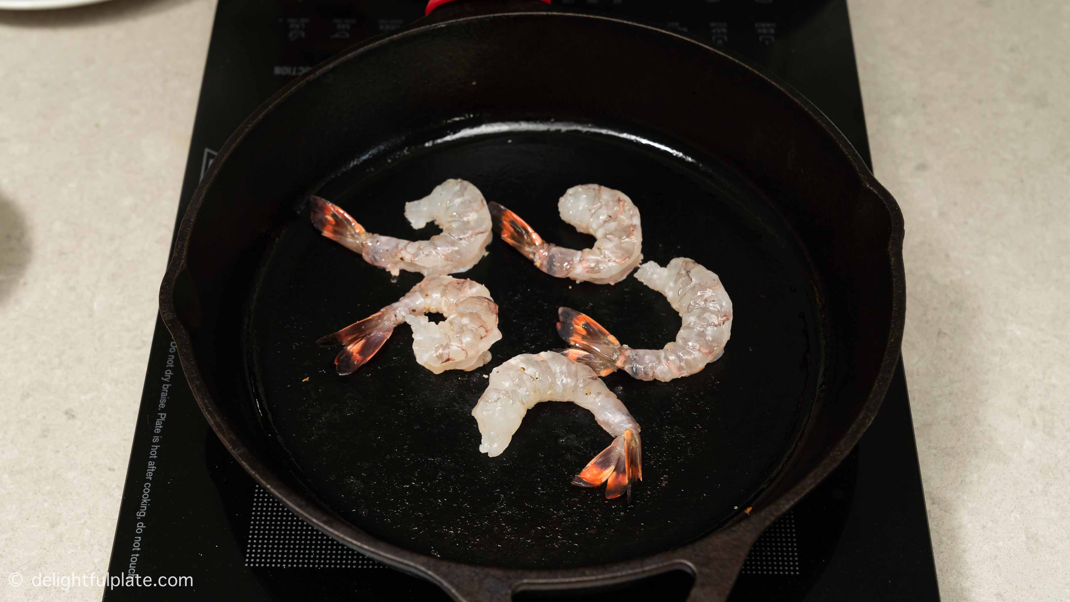 searing shrimp in a cast iron skillet.