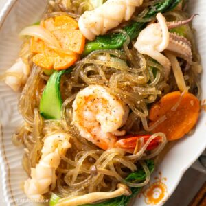 a plate of Vietnamese stir-fried glass noodles with seafood (Mien xao hai san).