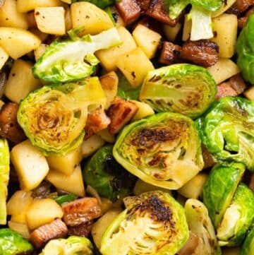 a pan of sautéed Brussels sprouts with bacon and apple.