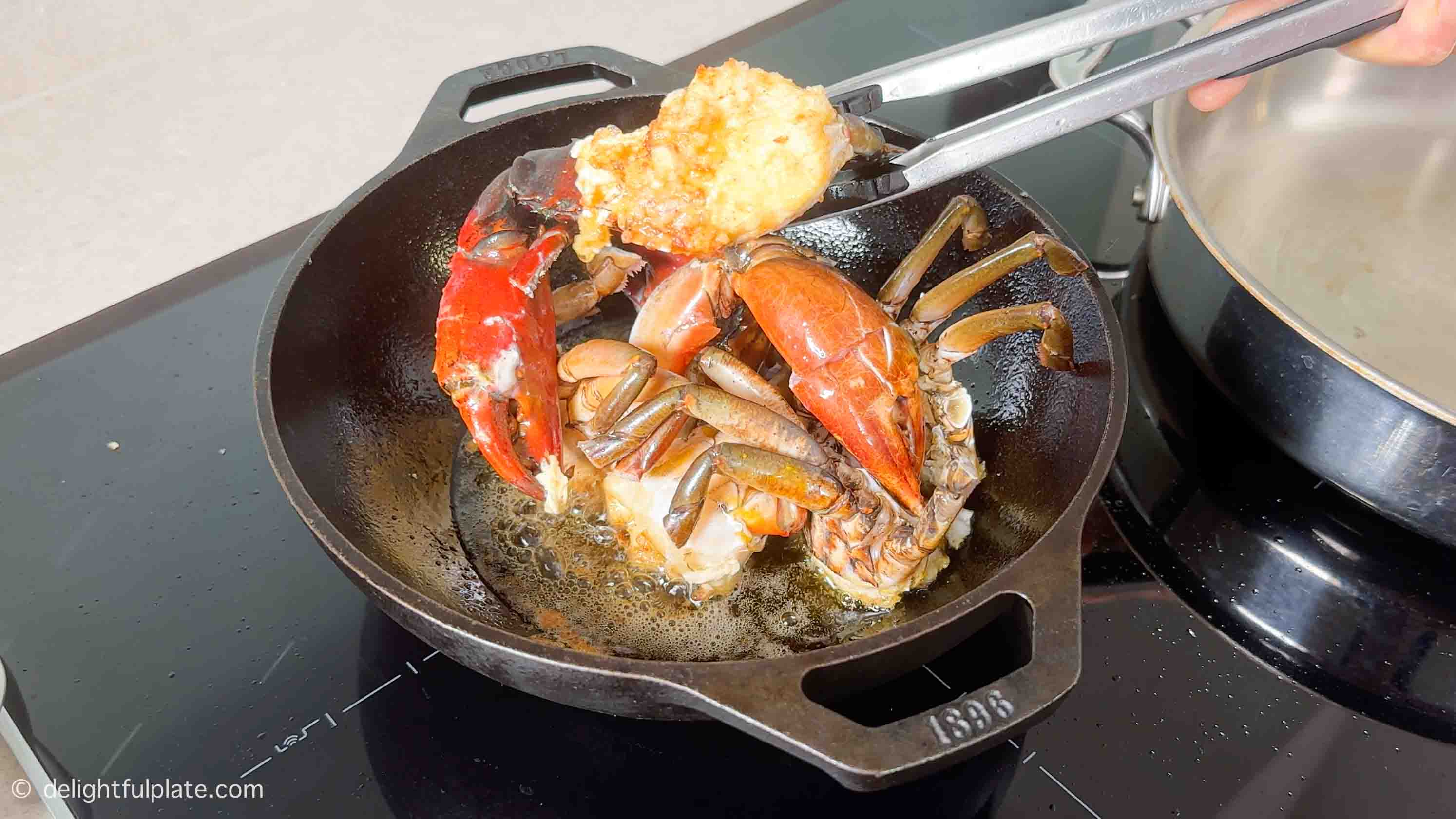 lightly golden fried crab pieces in a frying pan.