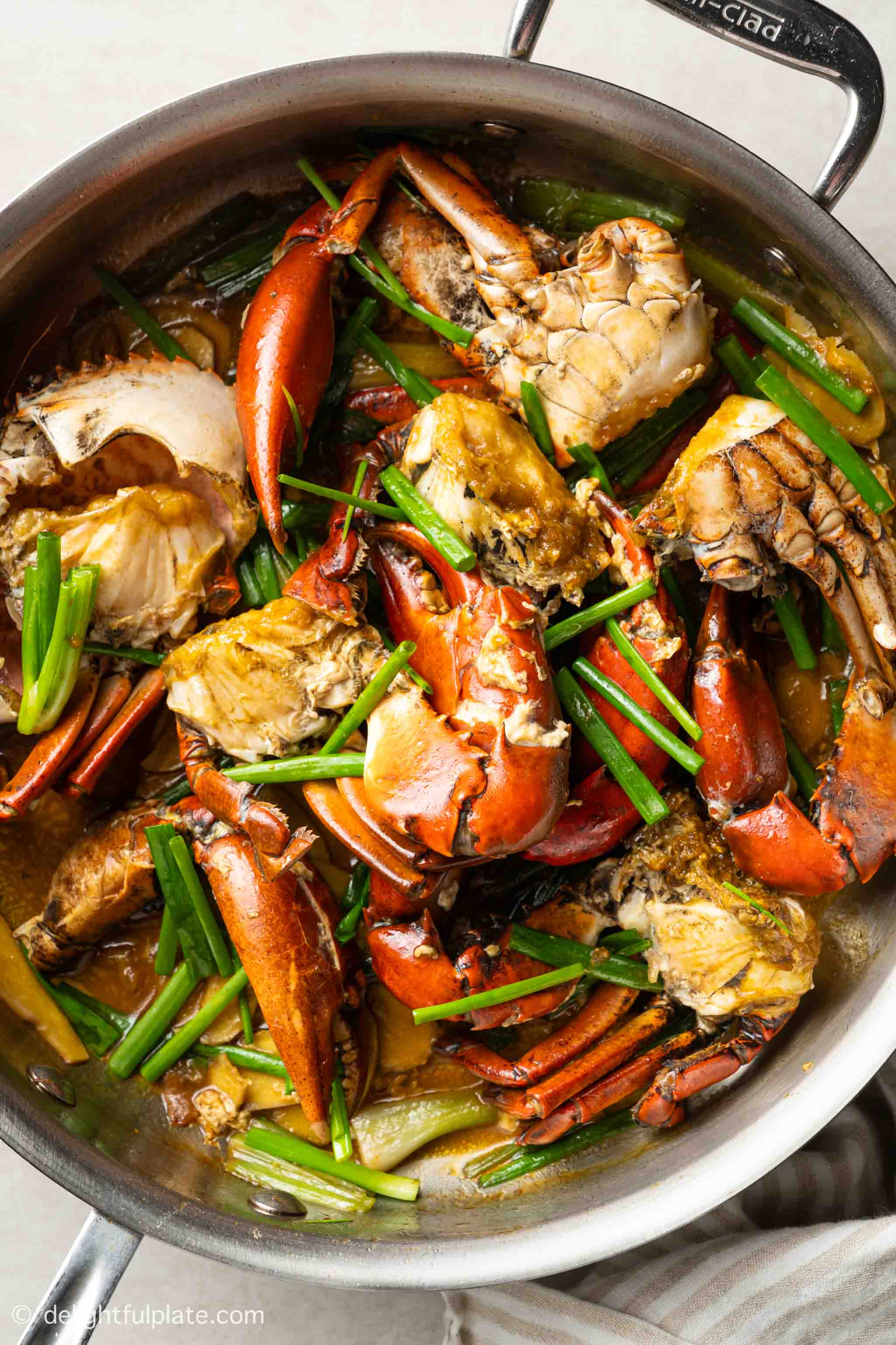a pan of freshly cooked crab stir-fry with ginger and scallion (cua xao hanh gung).