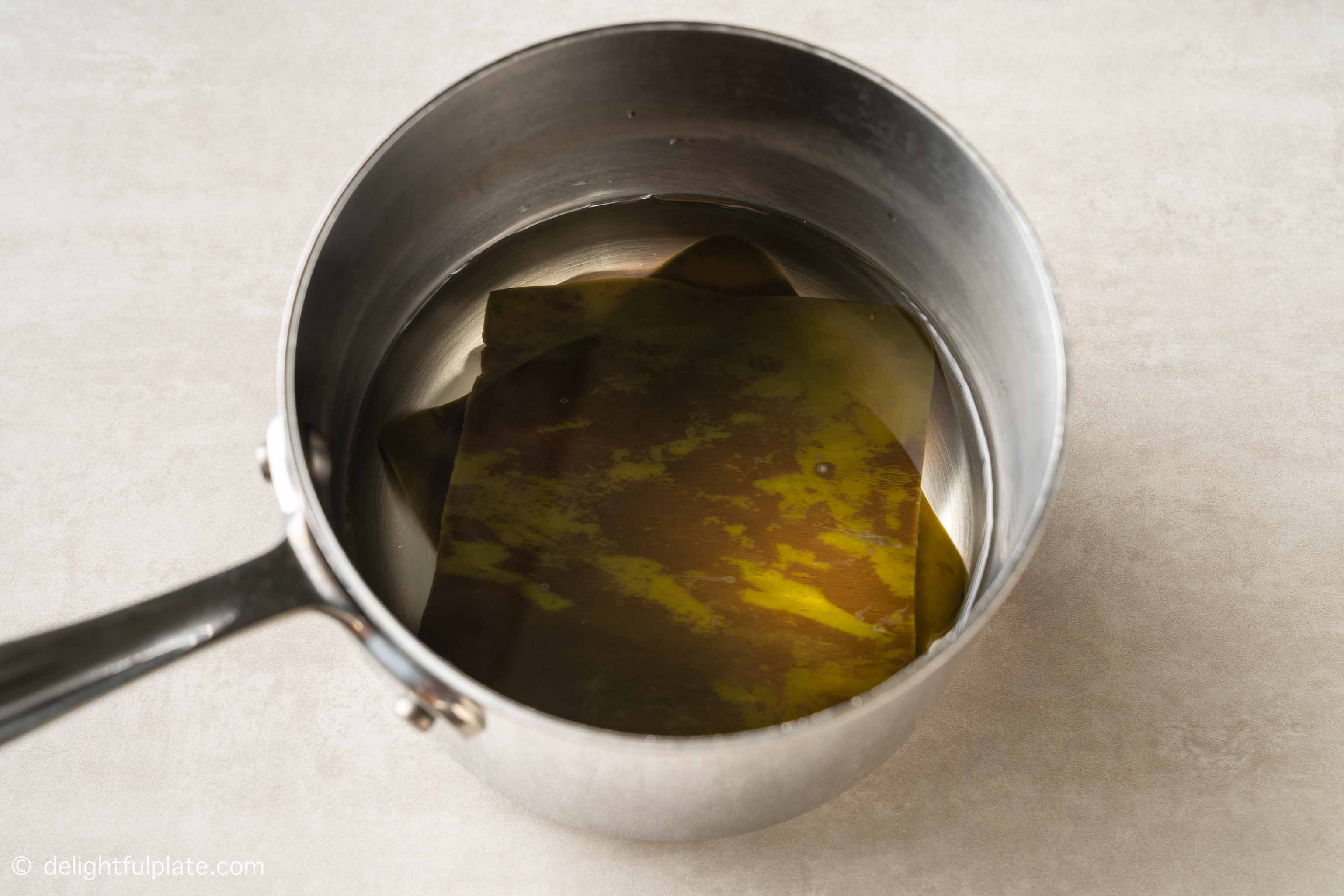 a pot with kombu soaked in water.