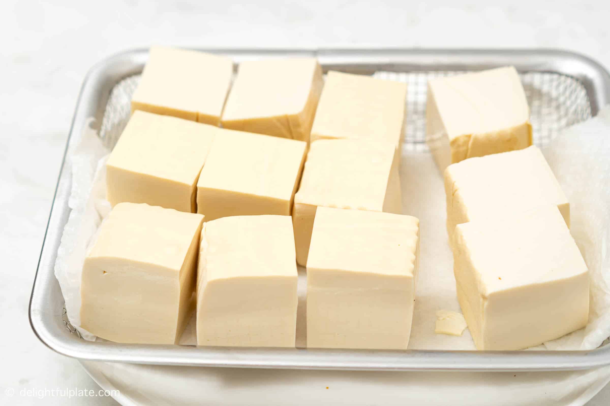 a plate of cubed soft tofu before frying.