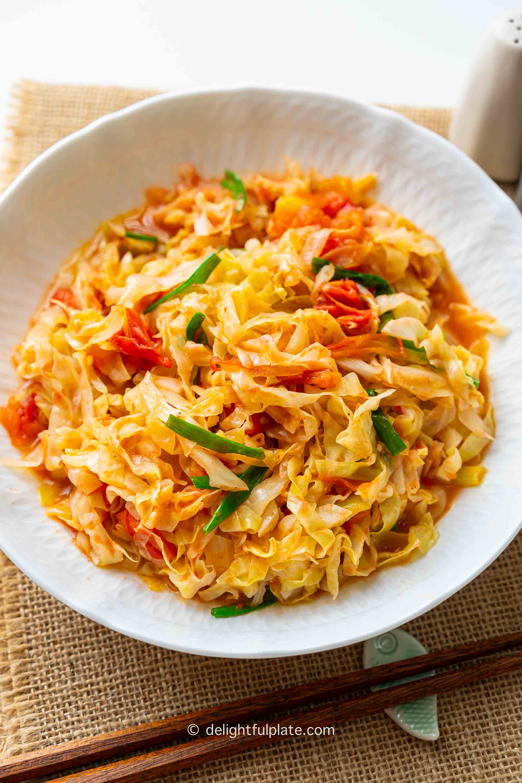 a plate of Vietnamese stir-fried cabbage with tomato.