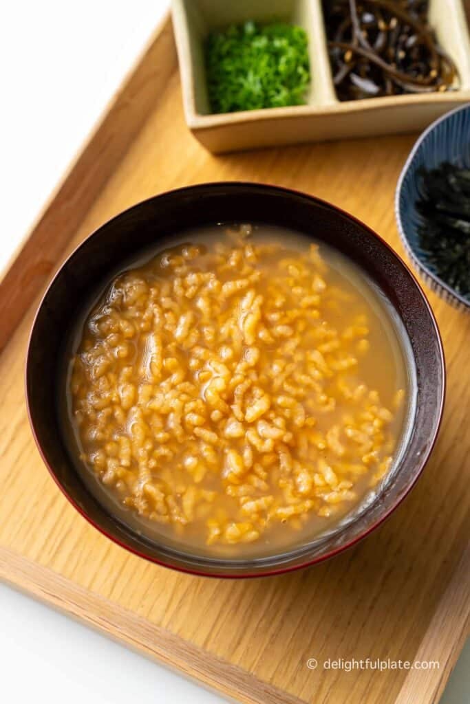 a bowl of traditional Japanese roasted tea porridge on a serving tray.