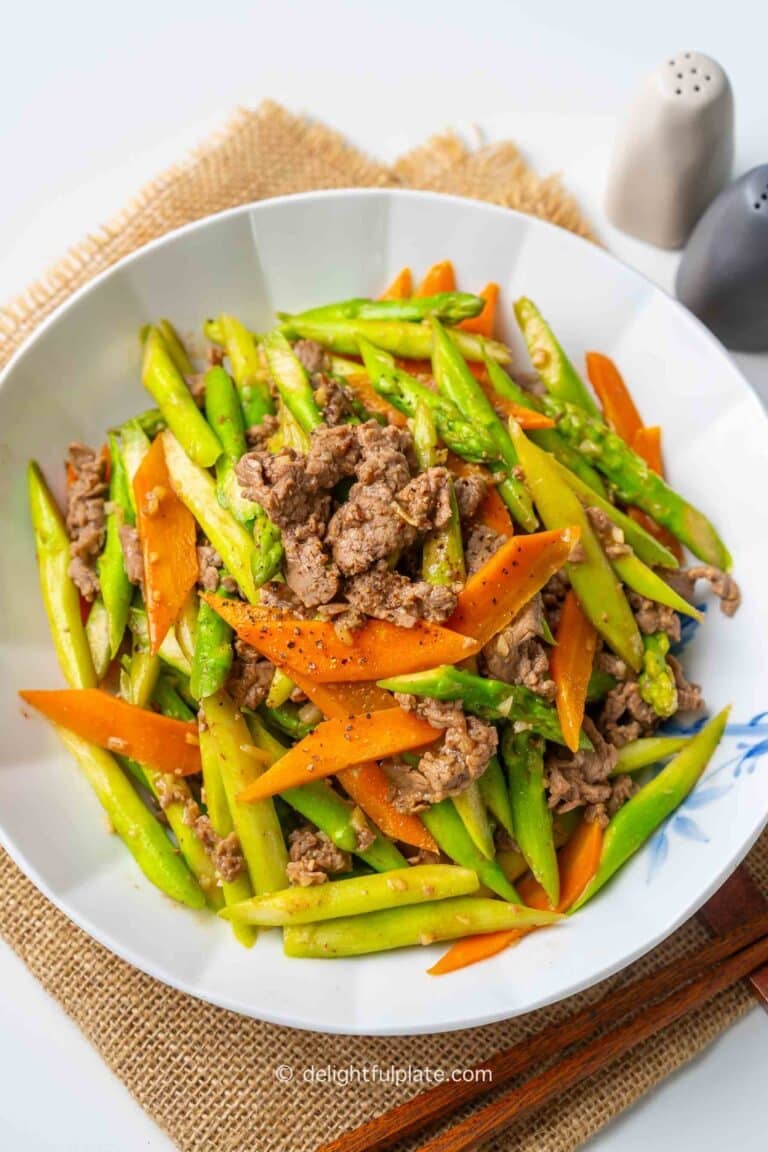 a plate of stir-fried asparagus with beef.