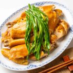 a plate of Vietnamese Steamed Chicken with Fish Sauce and Scallions (Ga Hap Mam Nhi).